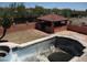 Aerial view of an empty swimming pool and ramada that needs repair work at 5716 E Desert Vista Trl, Cave Creek, AZ 85331