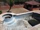 Aerial view of an empty swimming pool and ramada in disrepair at 5716 E Desert Vista Trl, Cave Creek, AZ 85331