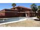 View of the home's exterior featuring a pool with an attached spa and red-tiled roof at 5716 E Desert Vista Trl, Cave Creek, AZ 85331
