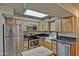 Bright kitchen featuring stainless steel appliances, wooden cabinets, and a skylight at 602 N May -- # 17, Mesa, AZ 85201