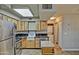 Well-lit kitchen features wood cabinets, stainless steel appliances, and an undermount sink at 602 N May -- # 17, Mesa, AZ 85201
