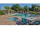 Community pool features a hot tub, lounge chairs, and patio tables with chairs at 602 N May -- # 17, Mesa, AZ 85201