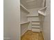 Functional walk-in closet with tile flooring and built-in shelving for optimal storage at 602 N May -- # 17, Mesa, AZ 85201