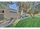 Attractive exterior view of a townhouse with mature trees, green grass, and manicured landscaping at 602 N May -- # 23, Mesa, AZ 85201