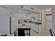 Well-lit kitchen boasts white cabinets, black countertops, and an island at 602 N May -- # 23, Mesa, AZ 85201