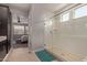 Bathroom featuring glass shower doors, tile floor, and access to the main bedroom at 6931 W Spur Dr, Peoria, AZ 85383