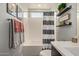 Bright bathroom featuring a modern vanity, a tub/shower, and decorative shelves at 6931 W Spur Dr, Peoria, AZ 85383