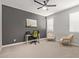 Bedroom featuring a gray accent wall, ceiling fan, and neutral decor, perfect for an office at 6931 W Spur Dr, Peoria, AZ 85383