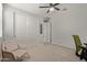 Neutral bedroom with a ceiling fan, plush carpet, and a closet with sliding doors at 6931 W Spur Dr, Peoria, AZ 85383