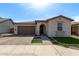 Charming single-story home featuring a well-manicured lawn, tile roof, and attached two-car garage at 6931 W Spur Dr, Peoria, AZ 85383