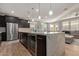 Modern kitchen featuring stainless steel appliances and a central island with a built-in wine cooler at 6931 W Spur Dr, Peoria, AZ 85383