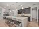 A modern kitchen features an island with barstool seating and stylish pendant lighting above at 6931 W Spur Dr, Peoria, AZ 85383