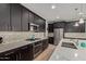 Well-equipped kitchen with modern appliances, dark cabinets, and light countertops at 6931 W Spur Dr, Peoria, AZ 85383