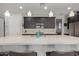 Bright kitchen featuring a large white marble countertop island with modern pendant lighting at 6931 W Spur Dr, Peoria, AZ 85383
