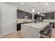 Contemporary kitchen with quartz countertops, pendant lighting, dark cabinetry and stainless appliances at 6931 W Spur Dr, Peoria, AZ 85383