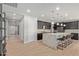 Modern kitchen featuring a large island with seating, dark cabinetry, and stainless steel appliances at 6931 W Spur Dr, Peoria, AZ 85383