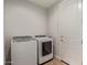 Bright laundry room with a side-by-side washer and dryer and wood look flooring at 6931 W Spur Dr, Peoria, AZ 85383