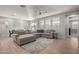 Open-concept living area with a large sofa, rug, and view of the dining area at 6931 W Spur Dr, Peoria, AZ 85383