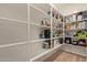 Organized walk-in pantry with ample white shelving for storing groceries and kitchen essentials at 6931 W Spur Dr, Peoria, AZ 85383