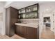 Dark wood cabinets with glass-fronted display cabinets and a wine rack at 7137 E Rancho Vista Dr # 4011, Scottsdale, AZ 85251