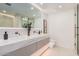 Bright bathroom showcasing double sinks with a vanity and glass shower at 7137 E Rancho Vista Dr # 4011, Scottsdale, AZ 85251
