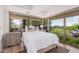 Bright bedroom featuring expansive windows with views of palm trees and greenery at 7137 E Rancho Vista Dr # 4011, Scottsdale, AZ 85251