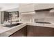 Stylish kitchen featuring granite countertops, stainless steel appliances, and bar area at 7137 E Rancho Vista Dr # 4011, Scottsdale, AZ 85251