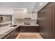 Contemporary kitchen with stone countertops, wood cabinets, and stainless steel appliances at 7137 E Rancho Vista Dr # 4011, Scottsdale, AZ 85251