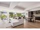 Bright living room featuring a white couch, wood floors, and large windows with a view at 7137 E Rancho Vista Dr # 4011, Scottsdale, AZ 85251