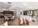 Modern living room with hardwood floors, a white couch, a kitchen and dining area in background at 7137 E Rancho Vista Dr # 4011, Scottsdale, AZ 85251