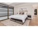 Bright bedroom with large windows, neutral colors, and a sleek, low-profile bed frame at 7137 E Rancho Vista Dr # 4011, Scottsdale, AZ 85251