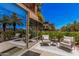 Charming outdoor seating area on patio, offering views of the neighborhood and nearby palms at 7137 E Rancho Vista Dr # 4011, Scottsdale, AZ 85251