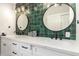 Modern bathroom with a dual vanity, striking green tile backsplash, and stylish fixtures, creating a spa-like ambiance at 736 S Winthrop Cir, Mesa, AZ 85204