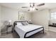 Neutral bedroom featuring a ceiling fan, carpet, and side tables at 736 S Winthrop Cir, Mesa, AZ 85204