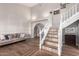 Bright living room with hardwood floors, stylish staircase, and ample natural light, creating an inviting space at 736 S Winthrop Cir, Mesa, AZ 85204