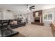 Spacious living room with a brick fireplace, comfortable seating, and neutral carpeting, perfect for relaxation at 736 S Winthrop Cir, Mesa, AZ 85204