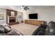 Bright living room features a brick fireplace, ceiling fan and built-in cabinet at 736 S Winthrop Cir, Mesa, AZ 85204