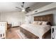 This spacious main bedroom offers an en-suite bathroom, closet, and a ceiling fan at 736 S Winthrop Cir, Mesa, AZ 85204