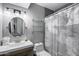 Bright bathroom with a modern vanity, shower, decorative mirror, and neutral wall colors at 7808 E Valley Vista Dr, Scottsdale, AZ 85250