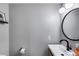 Well-lit powder room featuring a modern sink, sleek fixtures, and neutral wall colors at 7808 E Valley Vista Dr, Scottsdale, AZ 85250