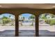 View of the community pool and lounging area framed by decorative arches at 7808 E Valley Vista Dr, Scottsdale, AZ 85250