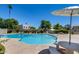 Inviting community pool with lounge chairs, picnic tables, and a well-maintained surrounding landscape at 7808 E Valley Vista Dr, Scottsdale, AZ 85250