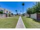 Picturesque walkway lined with palm trees and landscaping, offering a serene pathway through the community at 7808 E Valley Vista Dr, Scottsdale, AZ 85250