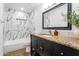 Updated bathroom features modern tile shower, granite countertop vanity, and stylish fixtures at 8021 W Hazelwood St, Phoenix, AZ 85033