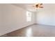 Bright bedroom featuring tile floors, a ceiling fan, and a window to let in natural light at 8021 W Hazelwood St, Phoenix, AZ 85033