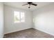 Bright bedroom featuring tile floors, a ceiling fan, and a window to let in natural light at 8021 W Hazelwood St, Phoenix, AZ 85033