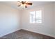 Bright bedroom featuring tile floors, a ceiling fan, and a window to let in natural light at 8021 W Hazelwood St, Phoenix, AZ 85033