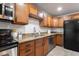 Updated kitchen features stainless steel appliances, granite countertops, and rich wood cabinetry at 8021 W Hazelwood St, Phoenix, AZ 85033