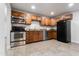 Spacious kitchen boasts stainless steel appliances, granite countertops, and ample cabinetry at 8021 W Hazelwood St, Phoenix, AZ 85033