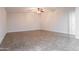 Spacious living area with tile flooring and a ceiling fan, ideal for relaxing or entertaining at 8021 W Hazelwood St, Phoenix, AZ 85033